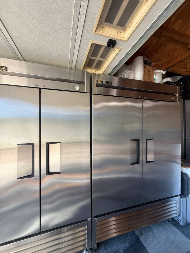 True two-door reach-in refrigerator during a temperature control check